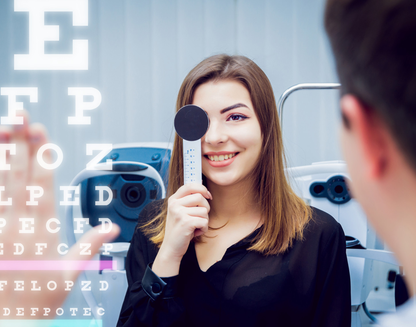 Young woman covering one eye with an occluder during an eye examination